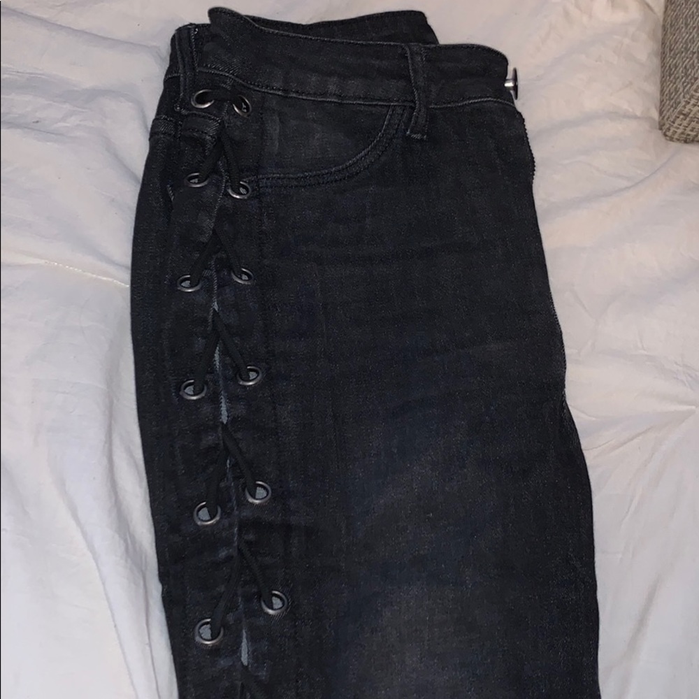 Entirely opened tied up black jeans
